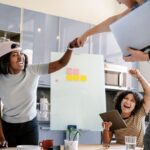 colleagues-doing-fist-bump-office_53876-149566