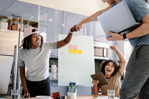 colleagues-doing-fist-bump-office_53876-149566